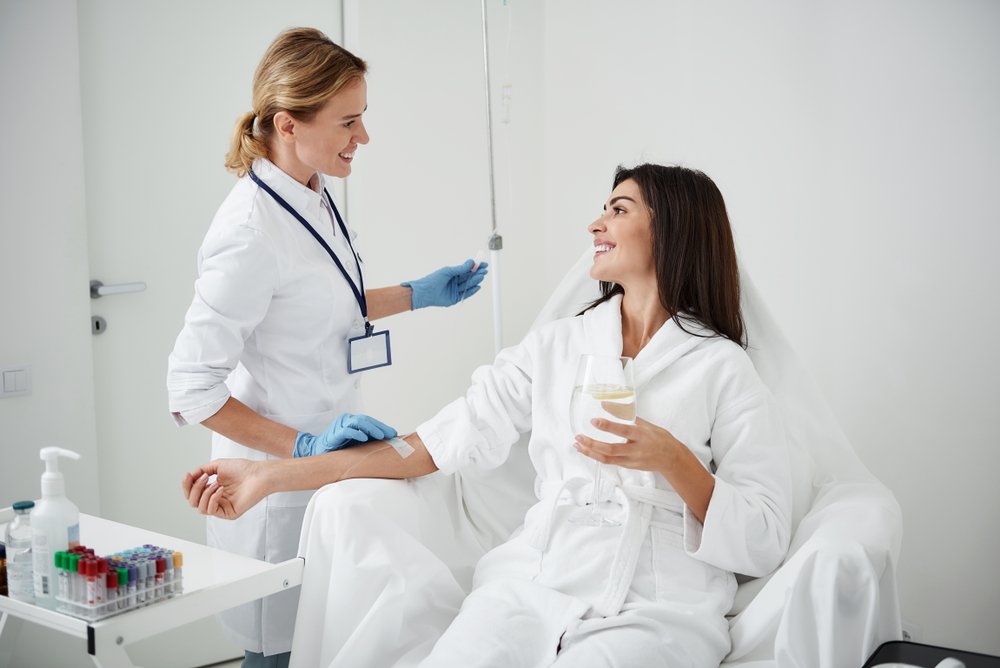 Woman receiving IV therapy