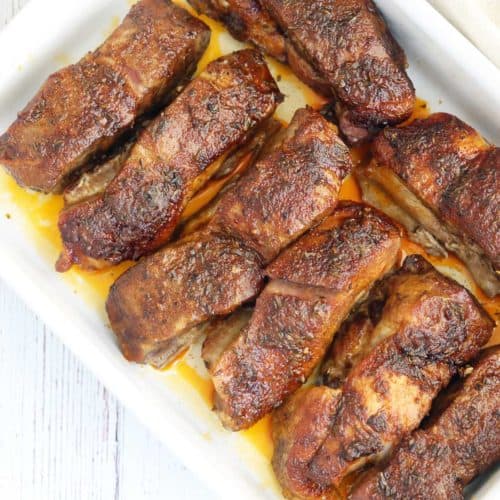 Country style ribs are served in a baking dish.