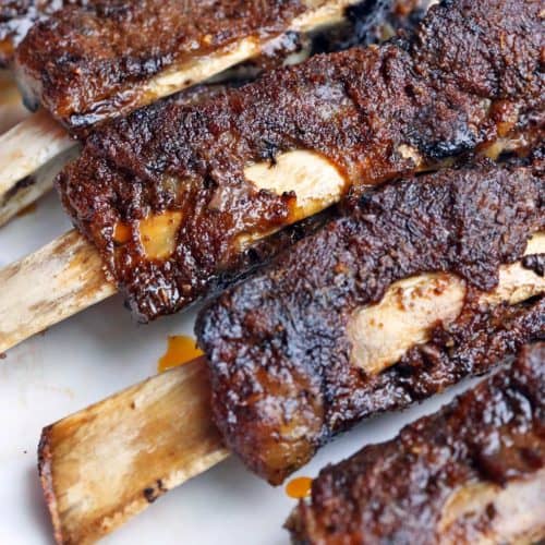 Slow cooker beef ribs on a baking sheet.