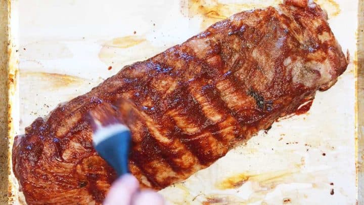 Brushing the ribs with BBQ sauce.