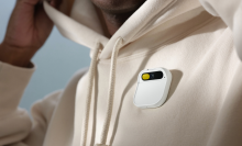 Humane's Ai Pin on someone wearing a white hoodie.