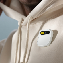 Humane's Ai Pin on someone wearing a white hoodie.