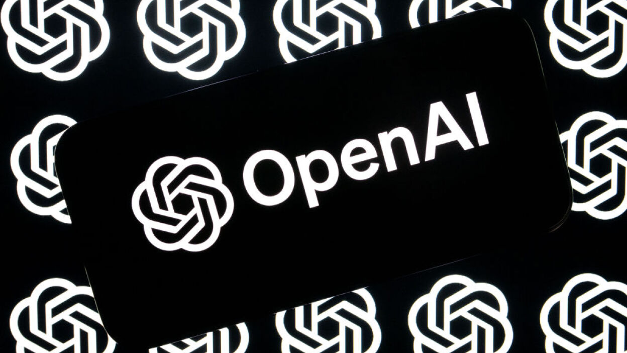 openai logo on a smartphone against a backdrop of a grid of openai logos