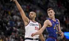 Nicolas Batum (33) of the LA Clippers makes a three pointer as Christian Braun (0) of the Denver Nuggets watches it go in during the first quarter at Ball Arena in Denver, Colorado on Wednesday, January 8, 2025.