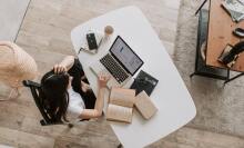 woman at a desk with papers and laptop