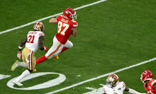 Travis Kelce runs with the ball