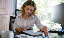 woman creating resume on tablet