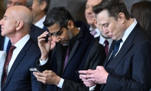 Google CEO Sundar Pichai and Tesla CEO Elon Musk look at their phones while Amazon's Jeff Bezos looks away.