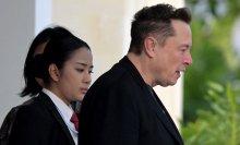 side profile of elon musk in a black jacket