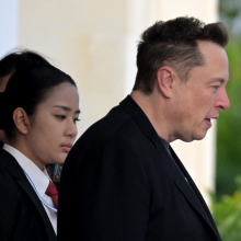 side profile of elon musk in a black jacket