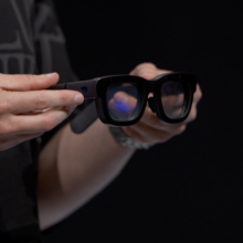 Pair of augemented glasses being held by hands