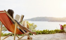 A woman relaxes and reads.