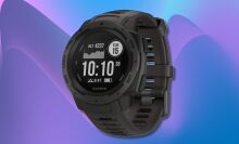 garmin instinct smartwatch against a purple and blue wavy background