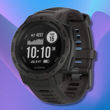 garmin instinct smartwatch against a purple and blue wavy background