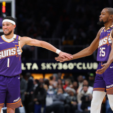 Devin Booker #1 and Kevin Durant #35 of the Phoenix Suns reacts against the Atlanta Hawks during the third quarter at State Farm Arena on January 14, 2025 in Atlanta, Georgia.