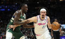 Jaime Jaquez Jr. #11 of the Miami Heat is defended by Taurean Prince #12 of the Milwaukee Bucks during the second half of a game at Fiserv Forum on January 23, 2025 in Milwaukee, Wisconsin.