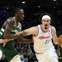 Jaime Jaquez Jr. #11 of the Miami Heat is defended by Taurean Prince #12 of the Milwaukee Bucks during the second half of a game at Fiserv Forum on January 23, 2025 in Milwaukee, Wisconsin.