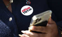 alia Cadet, TikTok creator and advocate, uses a phone outside of the U.S. Court of Appeals hears oral arguments in the case TikTok Inc. v. Merrick Garland on September 16, 2024 in Washington, DC.