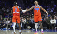 Shai Gilgeous-Alexander #2 of the Oklahoma City Thunder celebrates with Jaylin Williams #6 against the Philadelphia 76ers in the first half at the Wells Fargo Center on January 14, 2025 in Philadelphia, Pennsylvania. 