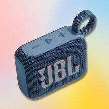 blue jbl go 4 portable speaker against a red, blue, and yellow gradient background