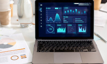 laptop displaying data graphics