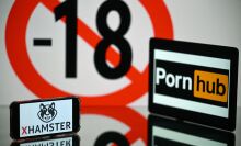 screens displaying an age restriction warning sign and the logos of the pornographic sites Pornhub (R) and Xhamster (L)