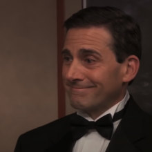 A man (Steve Carell) wearing a suit while smiling with tears in his eyes.