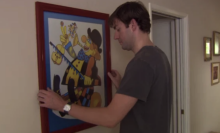 Jim tries to move the clown painting, to no avail.