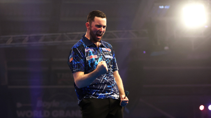 Luke Humphries of England celebrates victory