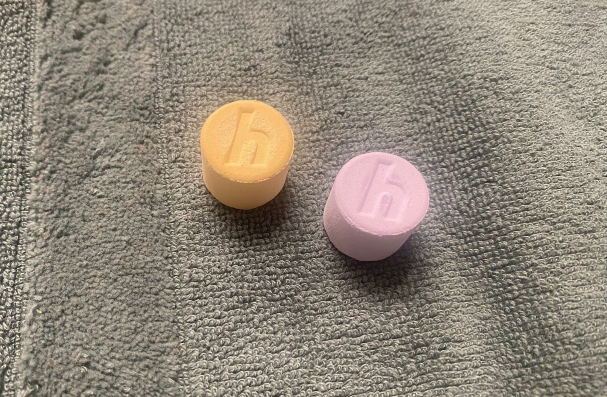 orange and purple tablets with hai's "h" logo engraved in them