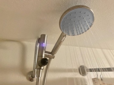 showerhead with pink LED light lit up