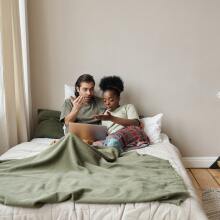 Couple watching laptop on bed