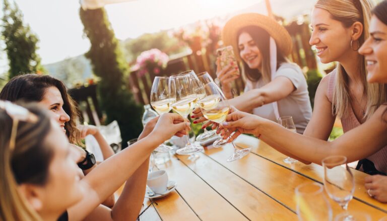 friends clinking glasses at brunch