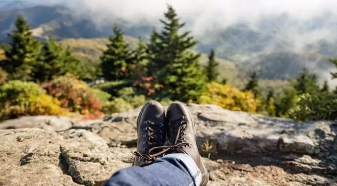 Image showing a man laying back on the ground and looking at the landscape