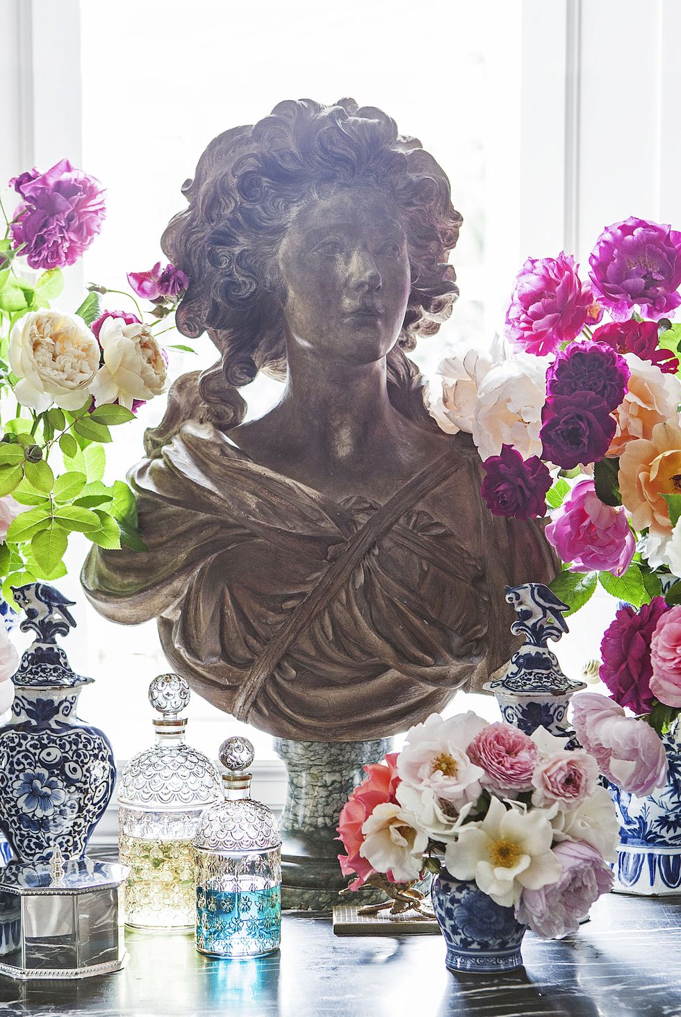 console table with a display of a bust and flowers