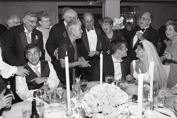 a lively gathering at a wedding reception with guests celebrating