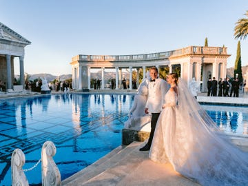 wedding couple by a reflective pool at a luxurious outdoor venue