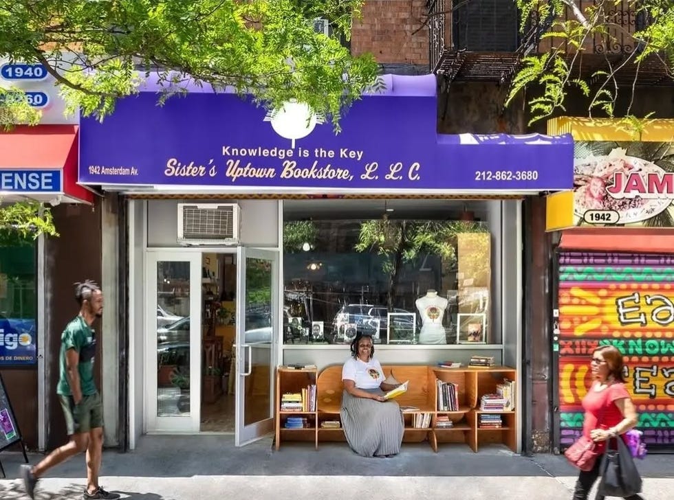 exterior view of sisters uptown bookstore with seating area