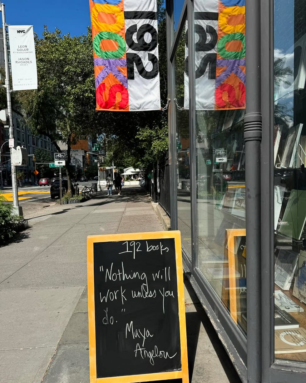 chalkboard sign and colorful banners outside a bookstore