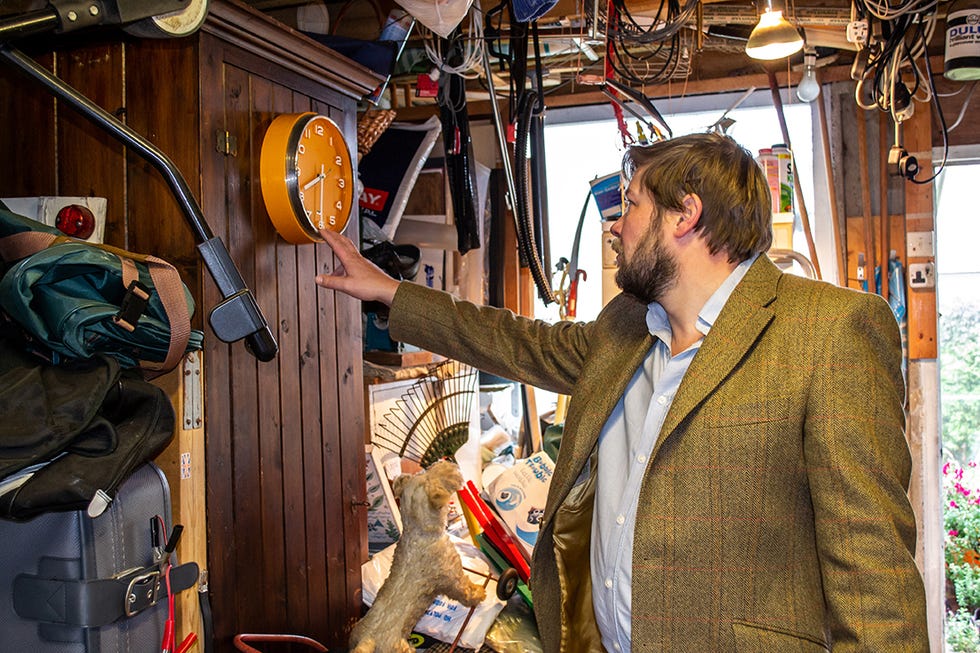 mcneill garage, angus ashworth pointing at clock on the wall