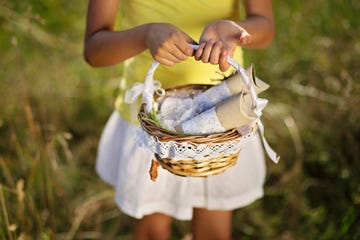 basket with gift packages held in a girl's hands