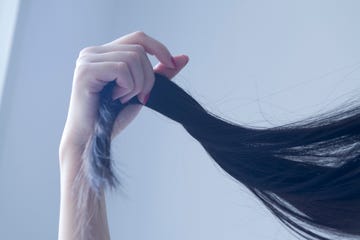 woman touching her hair