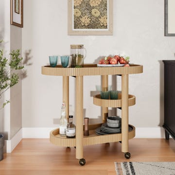 a wooden serving cart with drinks and fruit