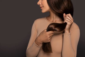 women holding on to her brunette hair