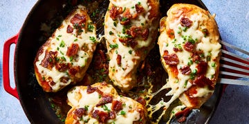 chicken breasts covered in bacon pieces and melted cheese