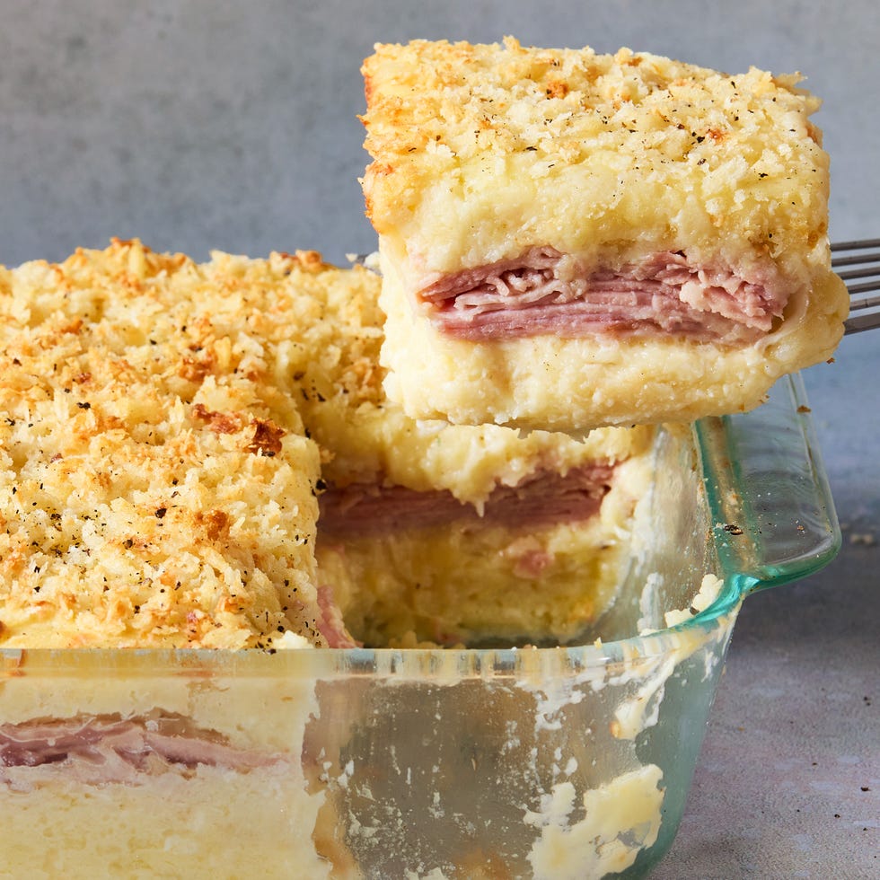 mashed potatoes layered with cheese and ham baked in a casserole dish