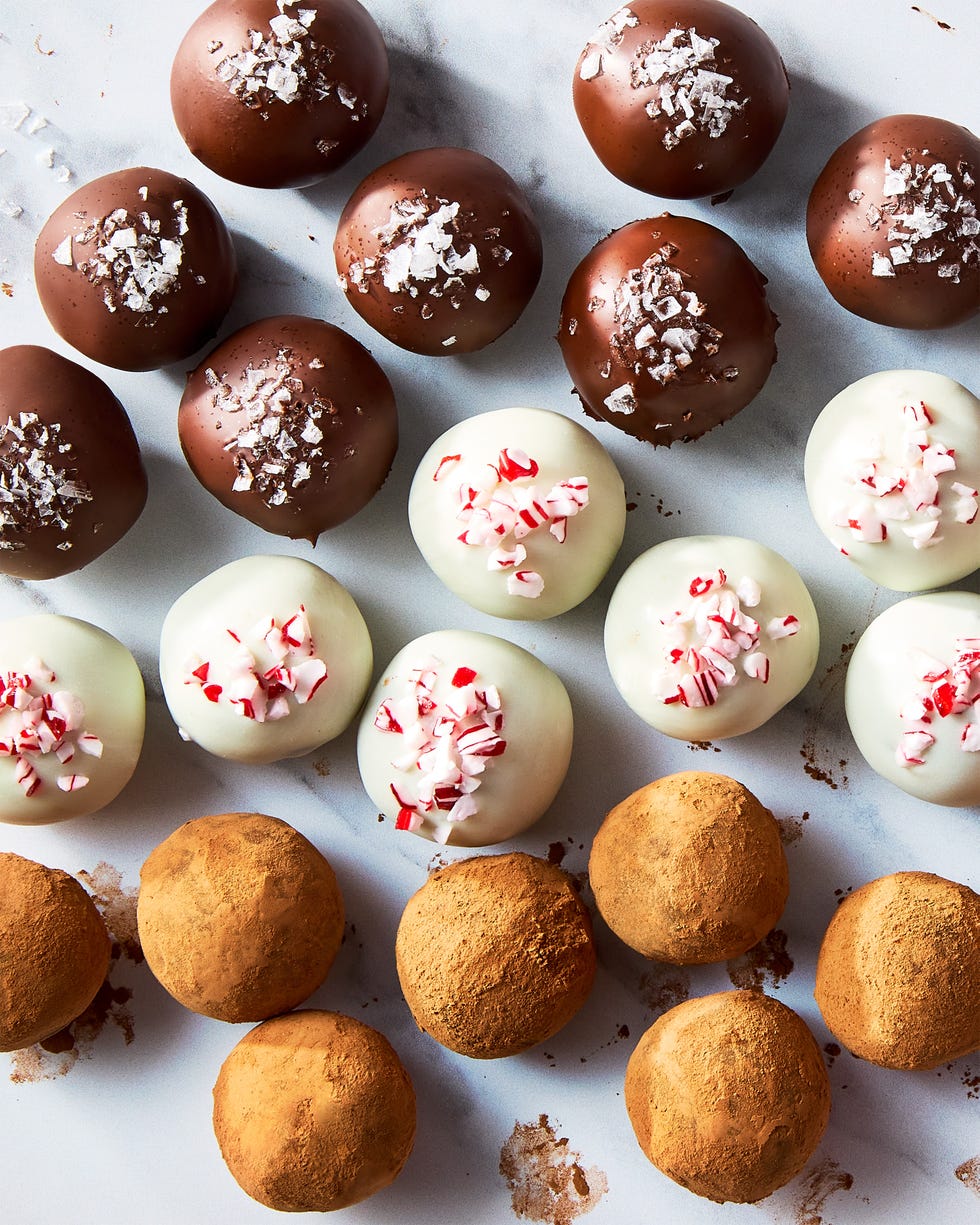 chocolate truffles topped with candy canes, sea salt, and cocoa powder