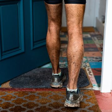 close up of a man entering the house with his dirty shoes after training