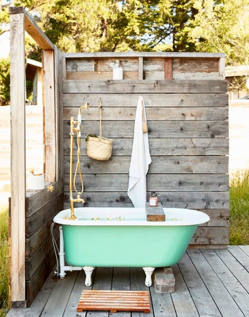 outdoor shower with with green claw foot tub, claw foot bathtub deck