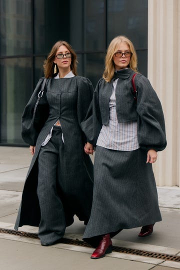 two women walking in coordinated stylish outfits